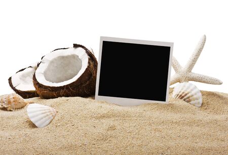 chopped coconut and photoframe on the sand in isolationの写真素材