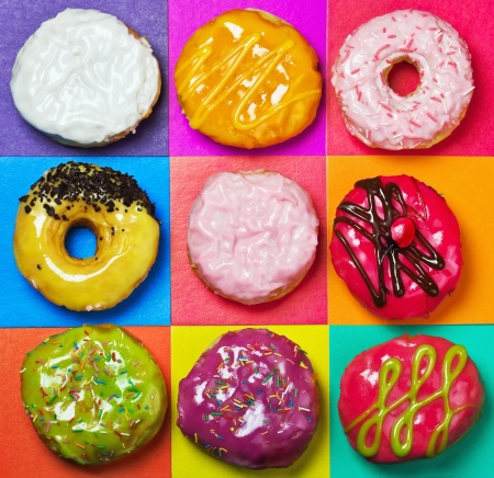 colored glazed donuts on a colored backgroundの写真素材
