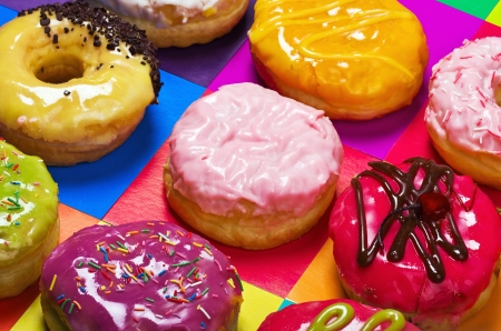 colored glazed donuts on a colored backgroundの写真素材