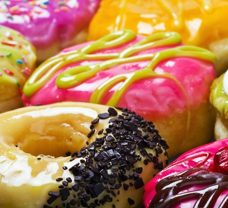 Glazed donuts in the range of background. Focus on the chocolate crumbの写真素材