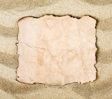 old burnt paper on the sea sandの写真素材