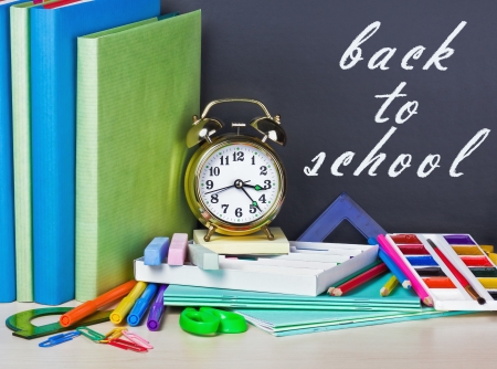 inscription on the chalkboard back to school and supplies for schoolの写真素材