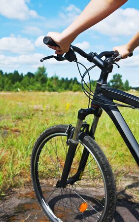 bike ride over rough terrain. Focus on the bicycle frameの写真素材