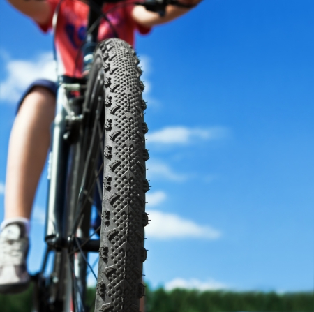 Mountain Bike and blue sky background. Focus on the front wheelの写真素材