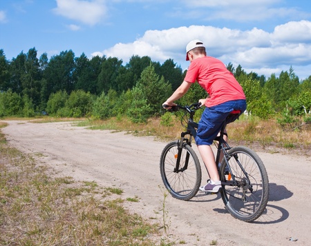 mountain bike teenager with blue sky riding on outdoor trail in natureの写真素材