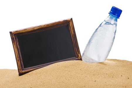 bottle of water and a black board for the text on the sandの写真素材