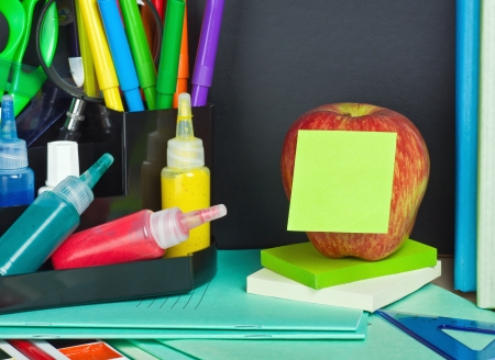 paper sticker pasted on the apple on the background of school suppliesの写真素材