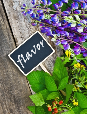 wild flowers and a black plaque with the inscription flavorの写真素材