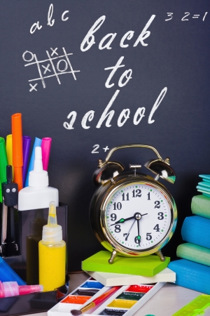 alarm clocks and school supplies on the backgroundの写真素材