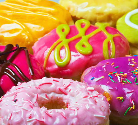 Colorful delicious donuts background. Focus on foregroundの写真素材