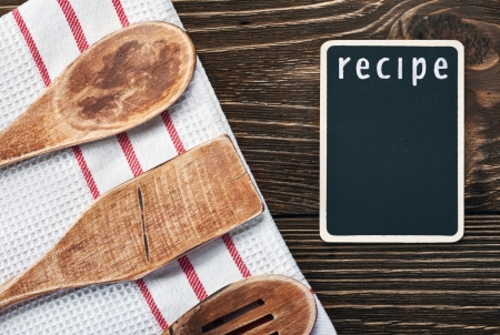 Wooden kitchen utensils and a blackboard to write a recipeの写真素材