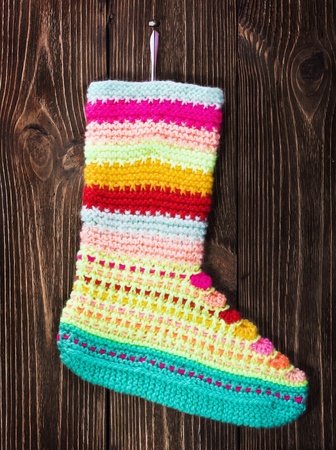 Christmas stocking hanging on the wooden backgroundの写真素材
