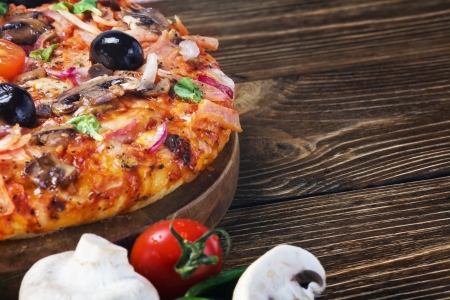 Delicious italian pizza served on wooden tableの写真素材