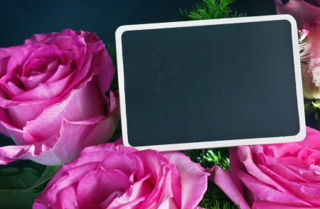 Pink rose and a blackboard for congratulationsの写真素材