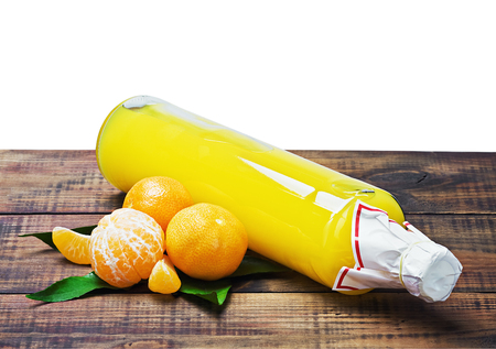 bottle with the juice of citrus fruits on the wooden tableの写真素材