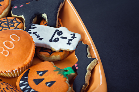 Halloween cookies on a plate orange and blackboardの写真素材