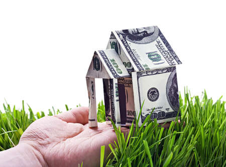House made of money in hand isolated on white backgroundの写真素材