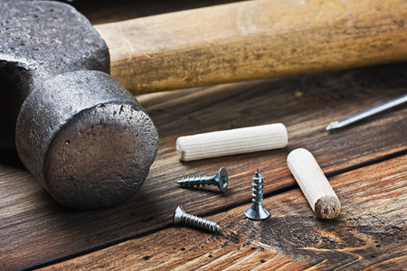 old tools for repairing lie on a wooden tableの写真素材