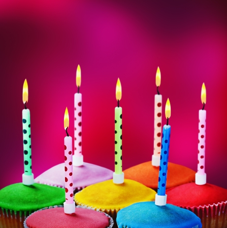 happy birthday cake shot on a crimson background with candlesの写真素材