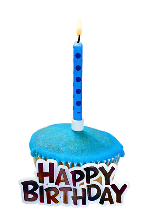 Birthday cupcake with a candle on a whiteの写真素材