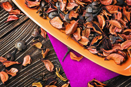 dry flowers in shades of orange on a wooden tableの写真素材