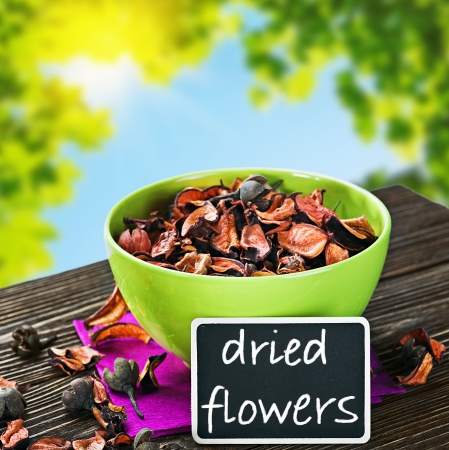 dried flowers and a black board for the text on a background of natureの写真素材