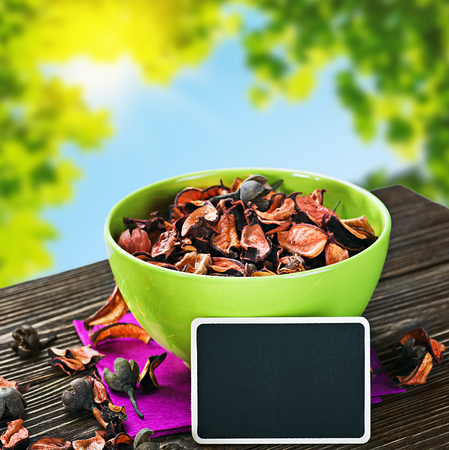 dried flowers and a black board for the text on a background of natureの写真素材
