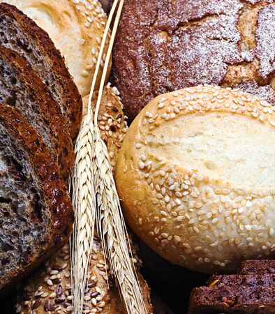 fresh bread and rolls with ears of wheat の写真素材