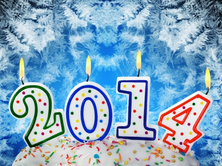 burning candles with the symbol of the new year on the cakeの写真素材