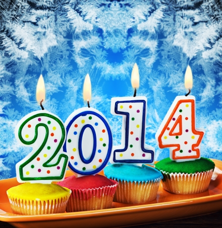 burning candles with the symbol of the new year on the cakeの写真素材