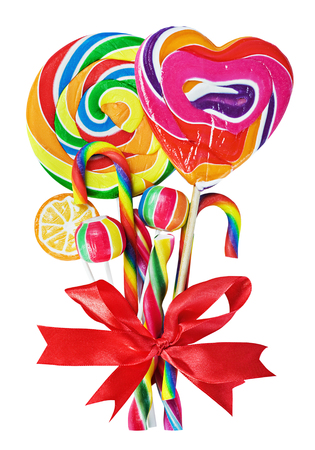 colored sweets with red ribbon bow isolated on whiteの写真素材