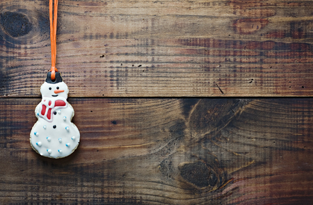 christmas gingerbread cookies hanging over wooden の写真素材