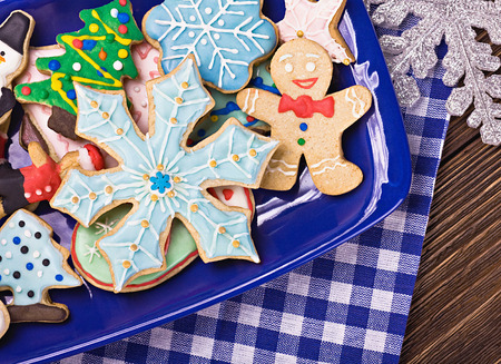 Christmas gingerbread cookies on a plate on the tableの写真素材