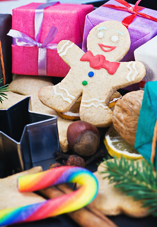 smiling on the background of Christmas gingerbread decorations for the holidayの写真素材