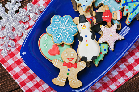 Christmas gingerbread cookies on a plate on the tableの写真素材