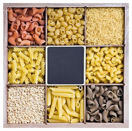 assortment of pasta in a wooden box and a blackboard for the textの写真素材