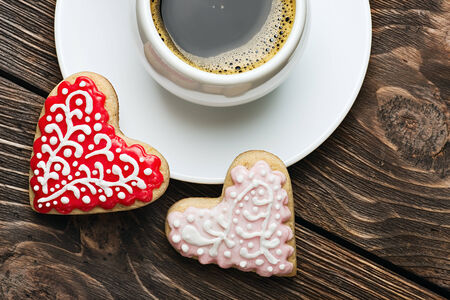 Heart shaped cookies baked on valentines day and a cup of coffeeの写真素材