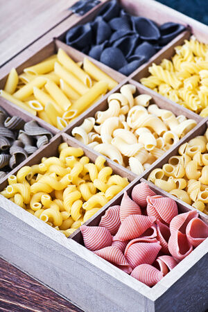 Italian pasta assortment of different colors background. Focus on the red pastaの写真素材