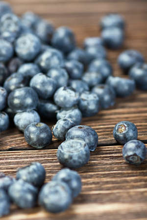 blueberries on old wooden table background. Shallow depth of fieldの写真素材