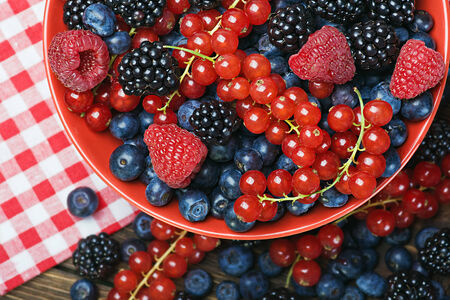 Assorted Fresh berries on a wooden tableの写真素材