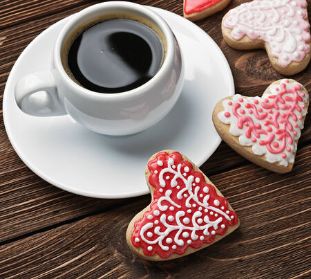 Heart shaped cookies baked on valentines day and a cup of coffeeの写真素材
