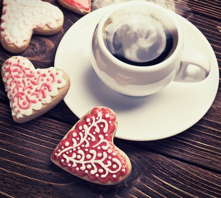 Heart shaped cookies baked on valentines day and a cup of coffee. toning techniqueの写真素材
