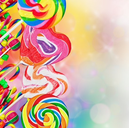 Colorful lollipops and sweets on a colored backgroundの写真素材