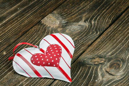 decorative heart toy on a wooden tableの写真素材