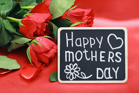 red roses and a blackboard with congratulations from mothers dayの写真素材