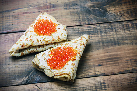 pancakes with red caviar on the tableの写真素材