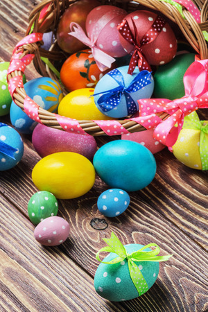 Colorful easter eggs in brown basketの写真素材