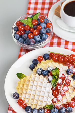 Waffles with fresh berries on the tableの写真素材