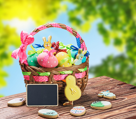 colored eggs in the basket on the tableの写真素材