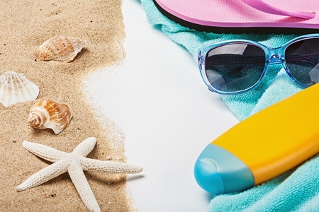 beach gear lie on the sand with shells. Focus on glasses Sun Protection and middle frameの写真素材